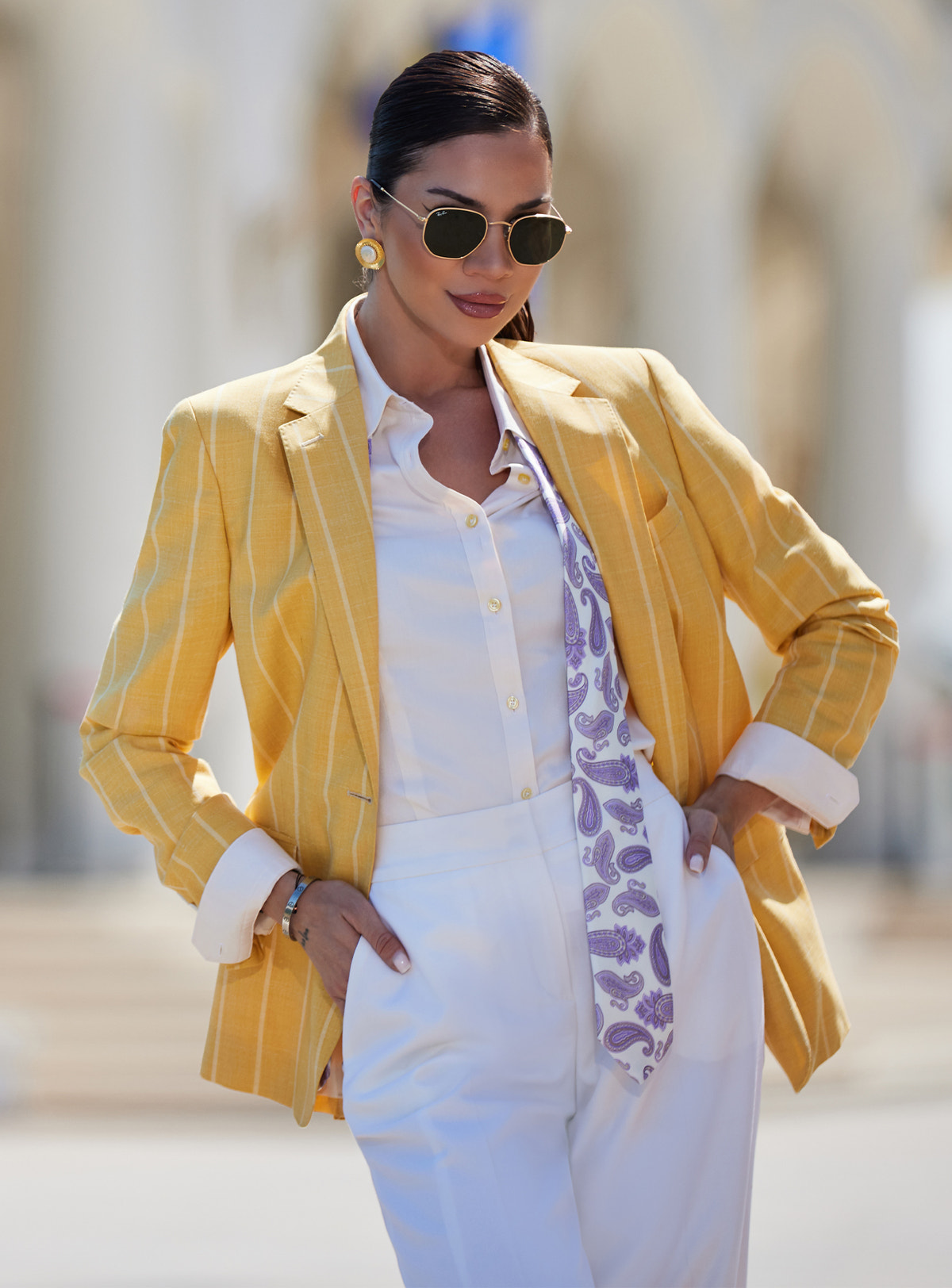 Sacou galben Consiglieri DONNA cu dungi albe, purtat cu pantaloni albi și eșarfă cu imprimeu